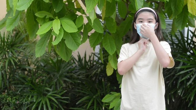 girl showing wearing a mask to prevent spreading germs to others During the spread of the coronavirus all over the world