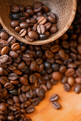 Spilled coffee beans and cocoa cup . Macro photography. Close up of coffee beans.