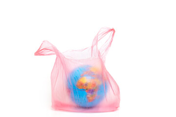 Planet Earth in a pink plastic bag. Conceptual image. The problem of environmental pollution by plastic.