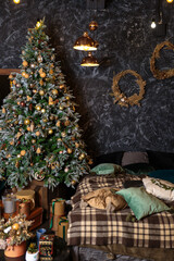 Christmas interior decoration. Old-fashioned gifts under christmas tree. Dark room christmas interior.