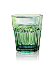 The cup is made of transparent glass with a green tint. Close-up on a white background with reflection