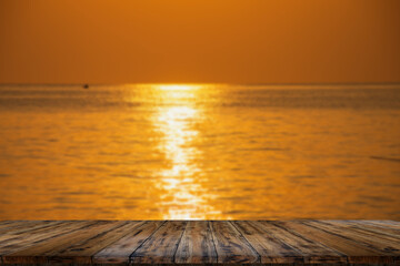Empty wooden table on beautiful blurred sea sunset