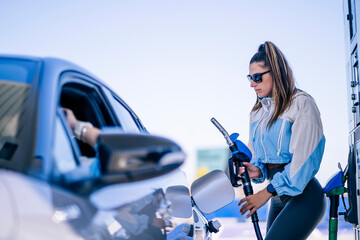 Woman refueling car with anonymous female