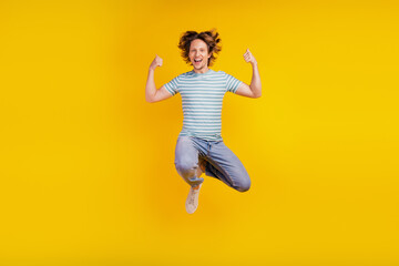 Fototapeta na wymiar Full-body photo of young cheerful man happy positive smile jump up show thumbs-up like isolated on shine yellow background