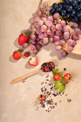 Grapes, strawberries on a light background. Fruit leaf tea