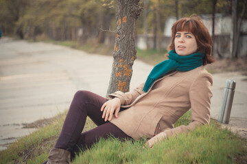 a girl in a coat by the water