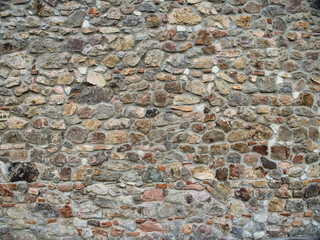 old wall of untreated stone, natural material