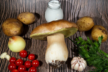 Mushroom Boletus edulis over Wooden Background, close up on wood rustic table. Cooking delicious organic mushroom.