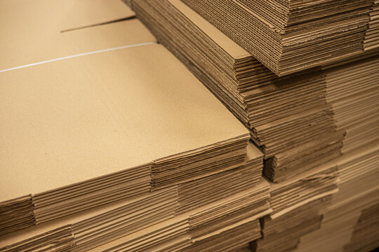Corrugated fiberboard brown box paper cardboard folded pile stack in factory