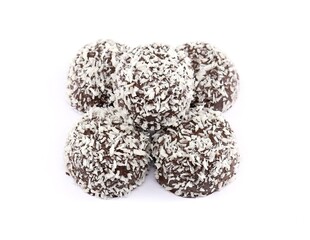 Cocoa balls with oatmeal covered with rasped coconut on white background.