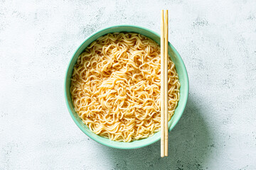 Instant noodles,Concept of tasty eating with bowl of noodles on gray background