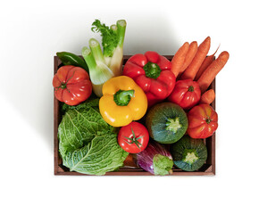 Fresh vegetables in a wooden box isolated from white background, top view