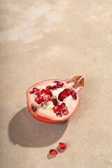 Half pomegranate on a light beige background