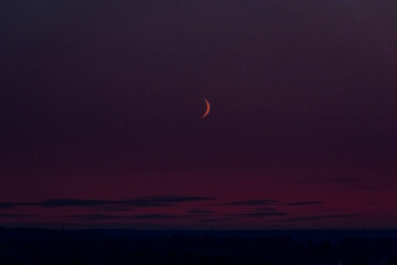 the rising moon at sunset