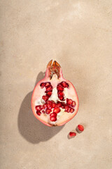 Half pomegranate on a light beige background
