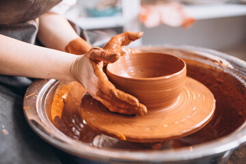 Female hands close up shaping clay pot