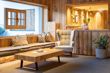 cozy rustic seating area with old wood, glass lights and retro armchairs