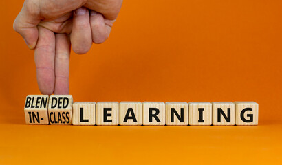 Blended or in-class learning symbol. Businessman turns cubes, changes words blended learning to...
