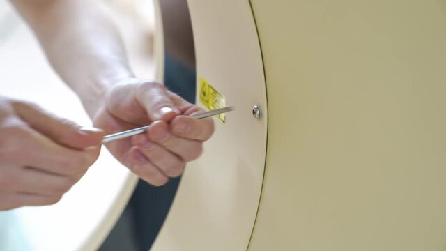 engineer assembles medical equipment after repair, installation, maintenance.
