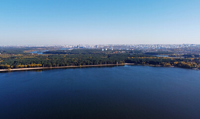 Fototapeta premium Panoramic aerial view of the forest coast of the sea. Autumn landscape