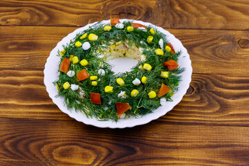 Salad Christmas wreath on a wooden table