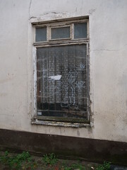 Fototapeta na wymiar Bemaltes Fenster eines verlassenen Hauses mit Figur