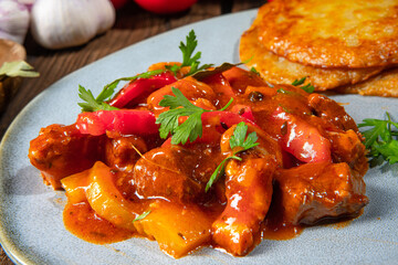 Original Hungarian goulash with potato pancakes