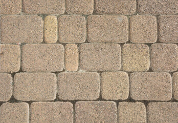 a fragment of a road made of geometrically regular stone. background for text