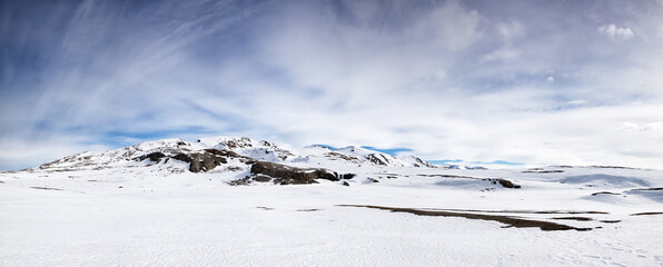 Panorama of the pristine snow-covered mountains of Svalbard