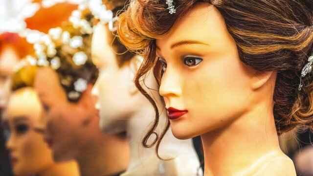 hair wig head hairdresser mannequin rows on display on some dummies in a store