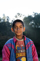 Almora, Uttarakhand- October 15 2021- Portrait of an indian village kid captured in sunrise. Indian farmer's kid in the fields.
