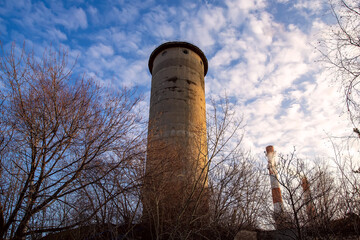 Old water tower on blue sky background.