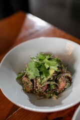 Demonstration of ready-made Georgian cuisine. Salad with fresh vegetables in walnut dressing