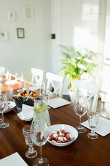 The table set for a buffet table in the Italian style. Caprese, homemade lemonade,