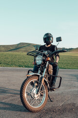 Fototapeta na wymiar a man in a helmet is sitting on a motorcycle