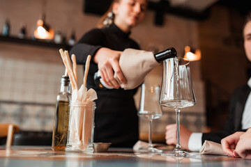 Wine is poured into a glass in a restaurant