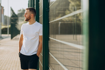 Fototapeta premium Young man standing at stadium in the morning