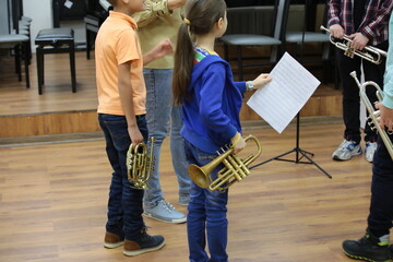 Group of children with trumpet and notes little boy girl and teenager band of young musicians stand...