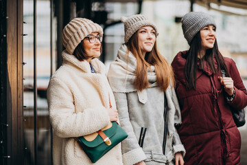 Three girls friends student in winter outfit outside the street