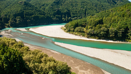 Jade-colored river flowing between the mountains