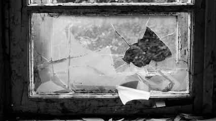 monochrome. horror, halloween. Smashed glass Window with old wooden frame. old window. finely broken glass. retro. cracked window frame. cracked old paint, pieces of glass. large pieces of glass. text