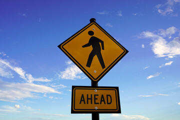 crossing ahead sign on sky background