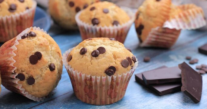 Muffins with chocolate chips on wooden background. Healthy ingredients sweets concept. Dolly shot 4k