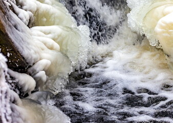 Fast river with ice and snow in late autumn