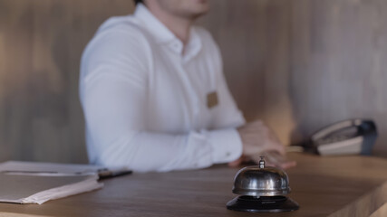 cropped view of hotel receptionist at hotel counter.