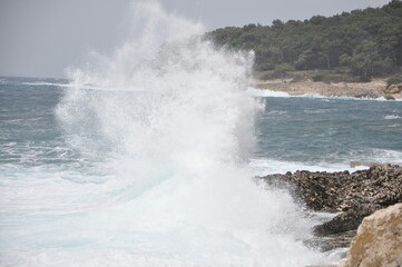 Storm on island coastline with waves and strong wind, Croatia. waves crashing on rocks. Island Losinj.