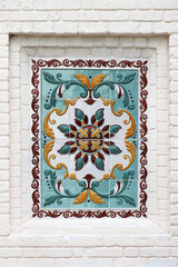 patterned tile on white brick wall