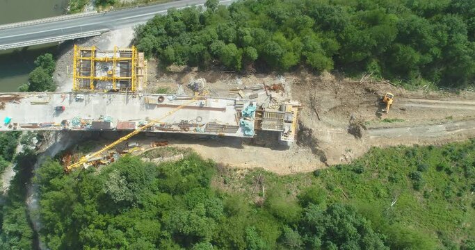 Road bridge construction. Aerial view of bridge construction over highway. View from above highway road repair. Building bridges on suburban road
