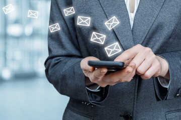Businesswoman is chatting by e-mail on a mobile device.