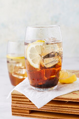 Iced tea with ice and lemon on a wooden table